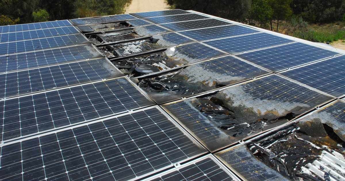 A damaged solar panel on a roof.